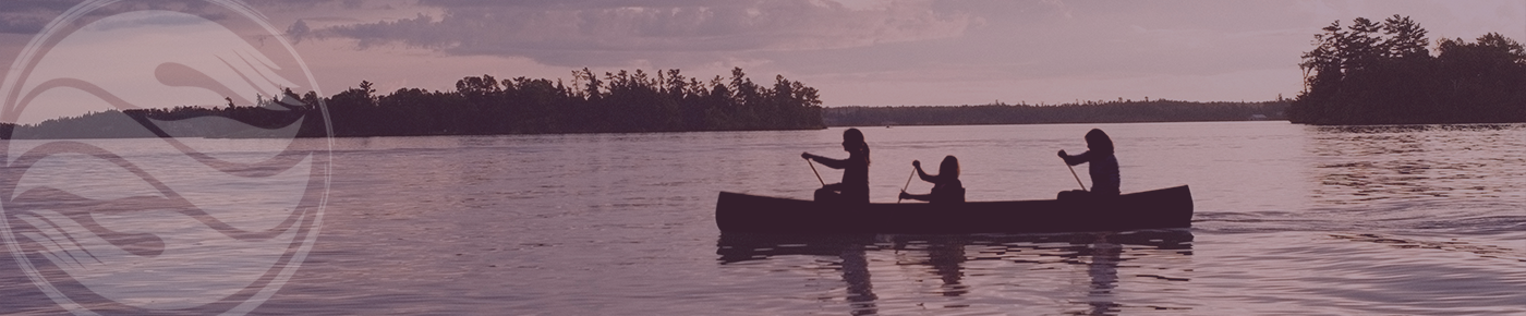 Three people canoeing on a lake